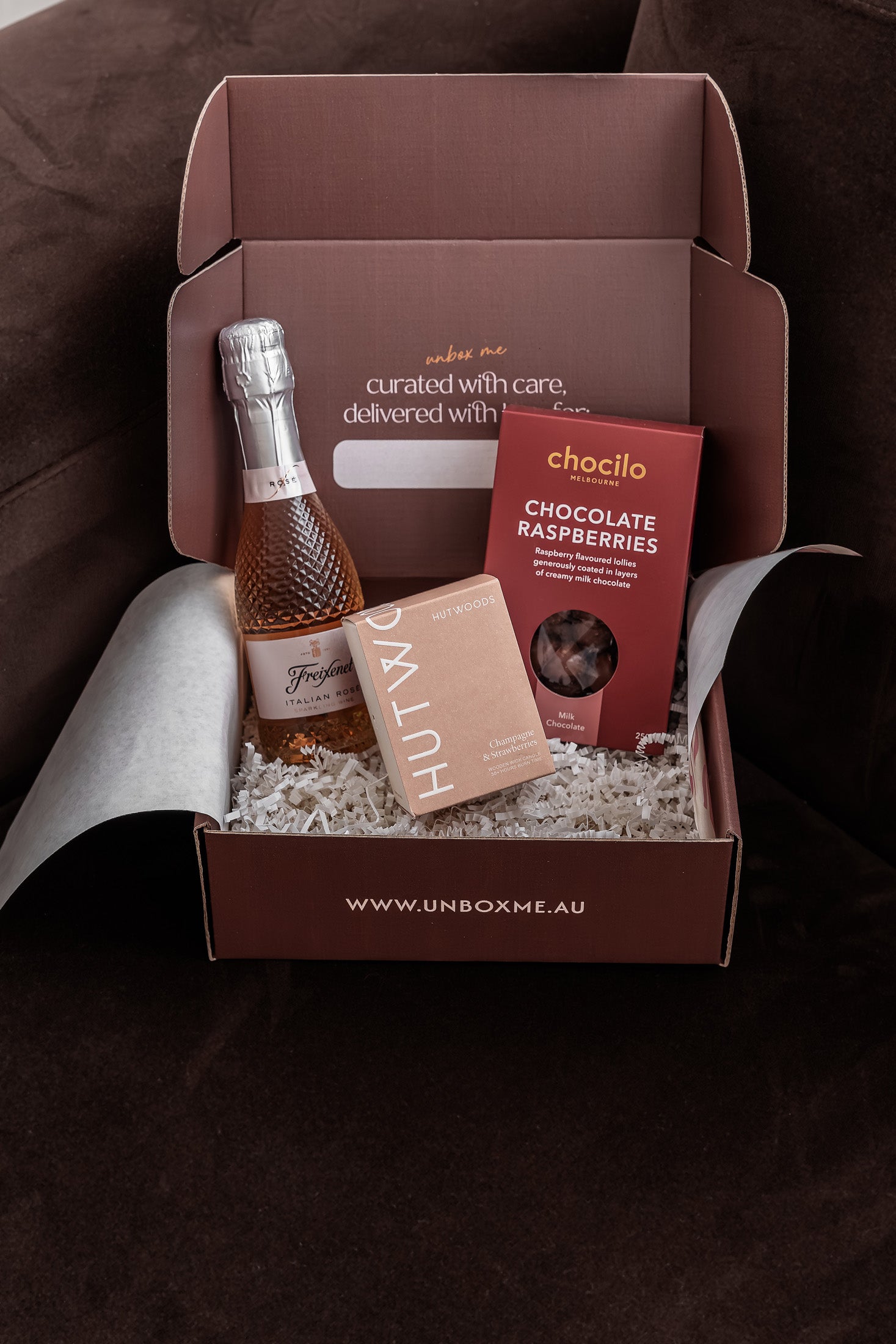 The Rosé & Relaxation Box by Unbox Me featuring sparkling rosé, chocolate raspberries and a Hutwoods candle.